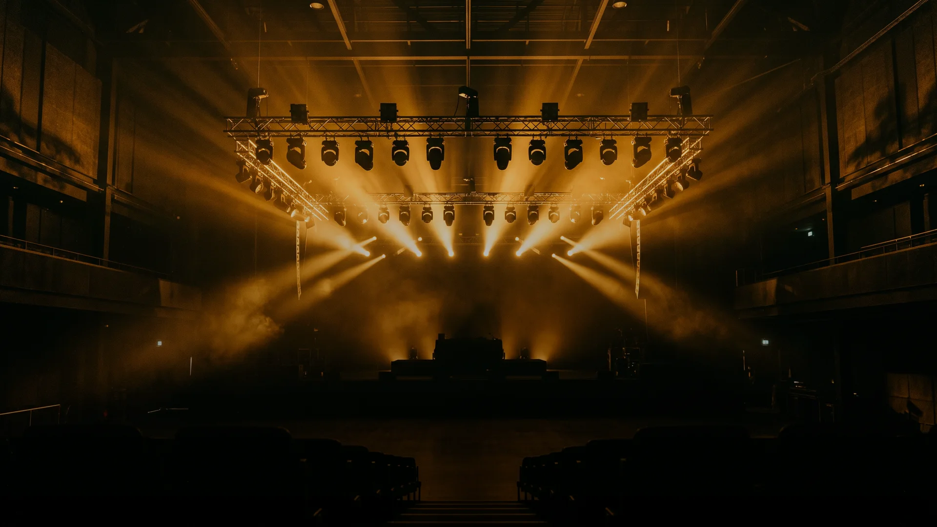 Entertainment venue with a concert lighting rig and stage systems
